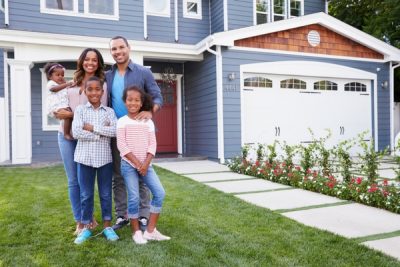 happy-black-family-in-front-of-beautiful-home